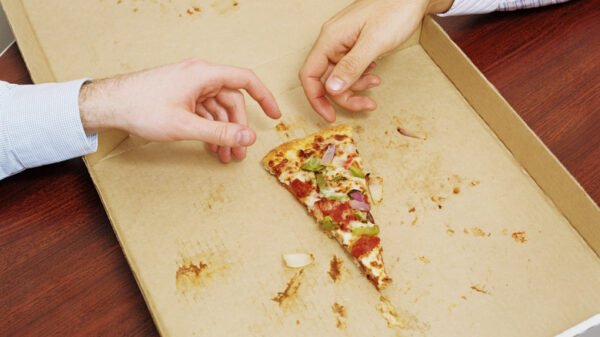 hands reaching for last slice